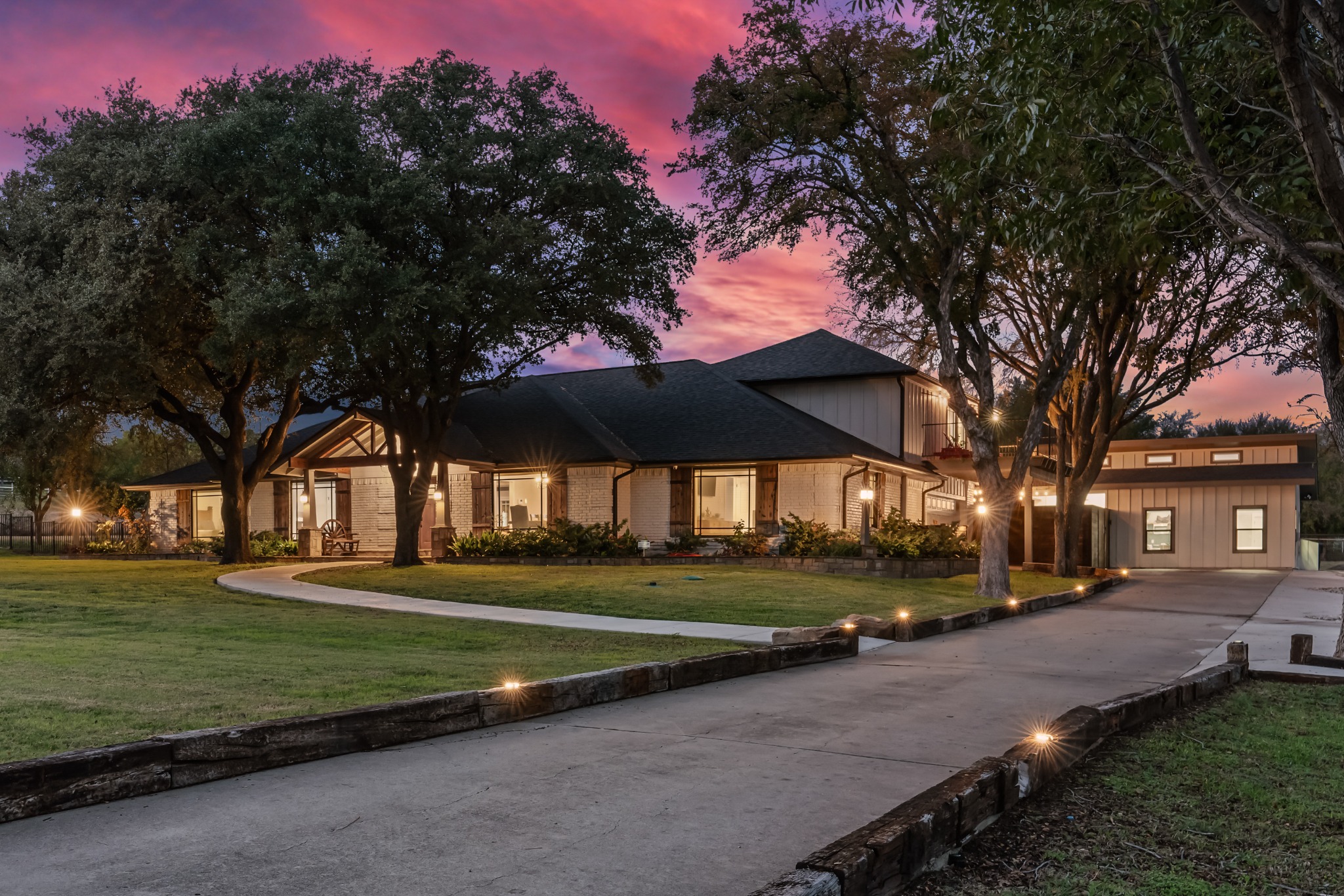 The front of Cowtown Casa beneath a rose-colored Texas sky